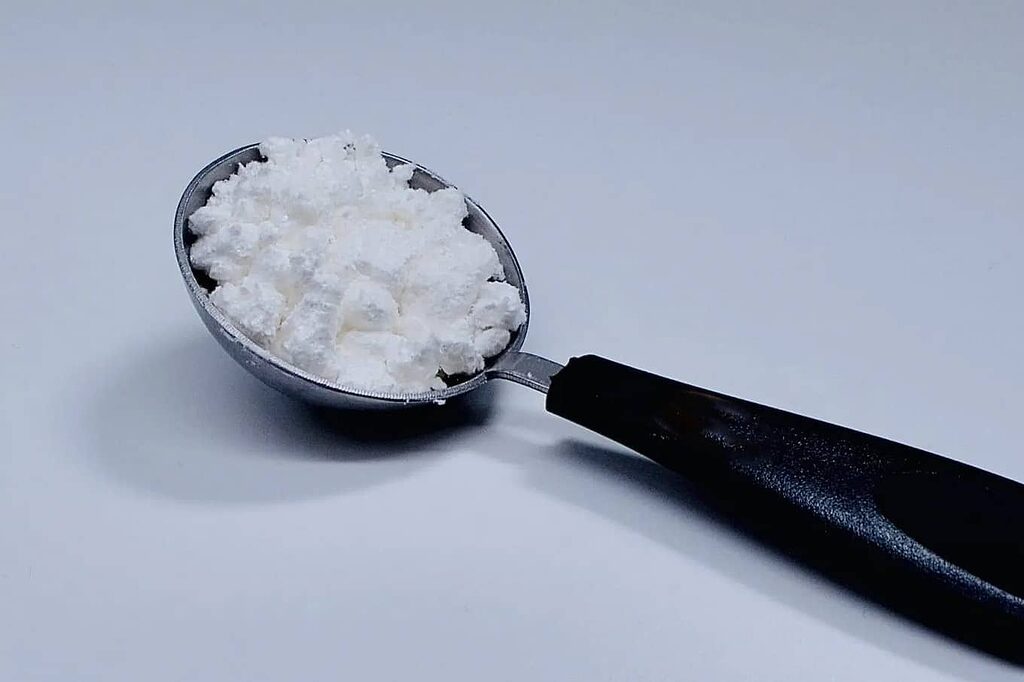 CBD isolate in a measuring spoon for accurate dosing.